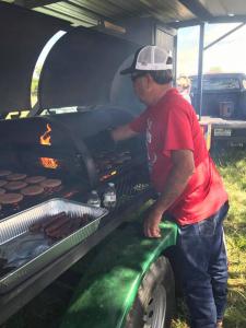James cooking the hamburgers and hot dogs!